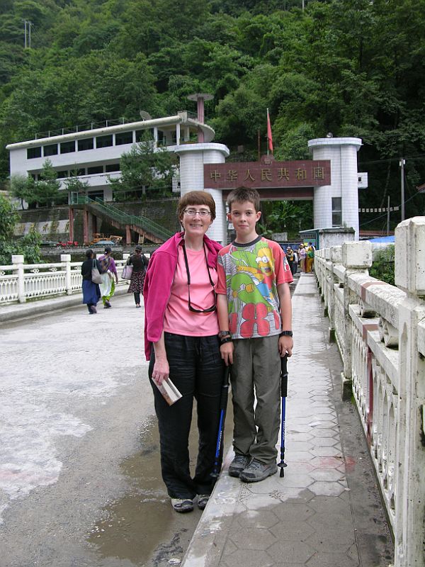 07 Charlotte Ryan And Peter Ryan On Friendship Bridge Between Kodari Nepal And Zhangmu Tibet After passing through the Nepalese border formalities in July 2006, Charlotte Ryan and Peter Ryan cross the Friendship Bridge between Kodari in Nepal and Zhangmu in Tibet.